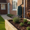 Watering a raised bed from a water butt with a watering can