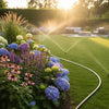 Hozelock timer on tap watering garden lawn.