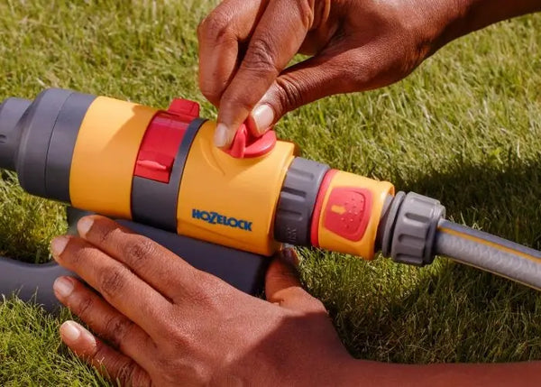 Person using a Hozelock garden Sprinkler on grass
