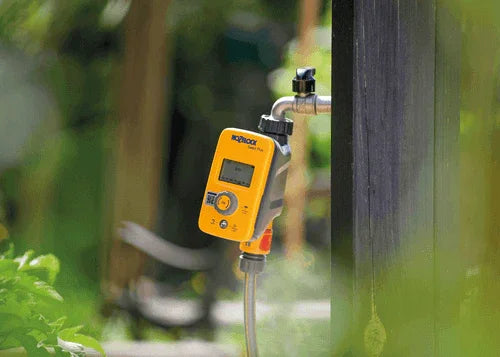 Hozelock timer on tap surrounded by greenery