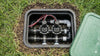 Underground irrigation system with pipes and valves in a grassy area