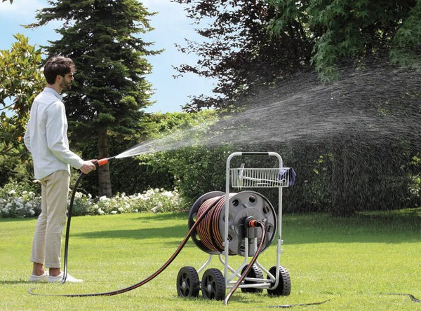 Claber Jumbo hose reel 8900 with person watering the Lawn