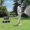 Man watering grass with a Claber Jumbo 8900 hose in a garden setting