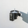 Claber 90844 Bluetooth Rain Sensor. Black outdoor light fixture on a white wall