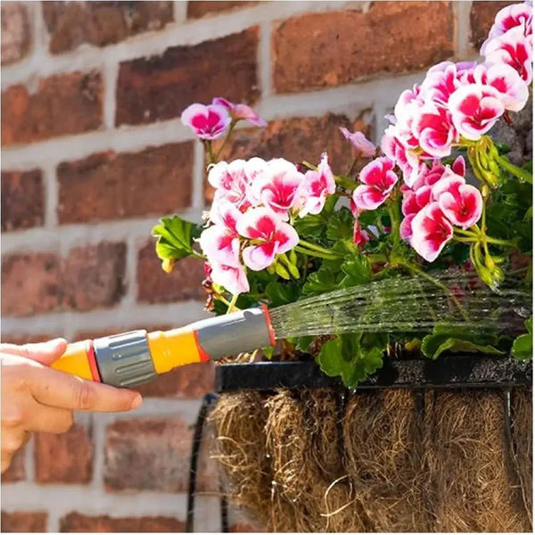 Person using a Hozelock Spray Nozzle to water planter