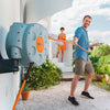 Man using a Claber rotoretractable garden hose with a visible brand logo, outdoors.oll