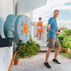 Man using a Claber rotoretractable garden hose with a visible brand logo, outdoors.oll