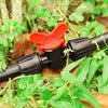 Garden irrigation valve with red handle in a natural setting