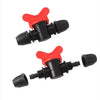 Two black and red plastic Irrigation valve components on a white background