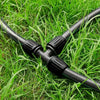 irrigation Black garden hose with connectors on green grass