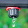Close-up of a Antelco CETA dripper with water droplets on a blurred green background