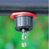 Close-up of a Antelco CETA dripper with water droplets on a blurred green background