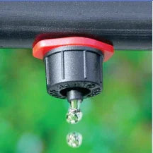 Close-up of a Antelco CETA dripper with water droplets on a blurred green background
