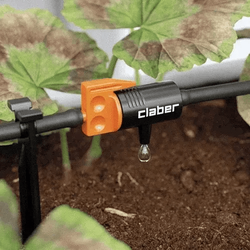 Claber irrigation system on a garden hose with plants in the background