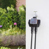 Claber Dual Select 8488 Garden irrigation system with two nozzles attached, set against a garden background.