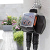 Claber Gardening controller attached to a garden faucet with plants in the background