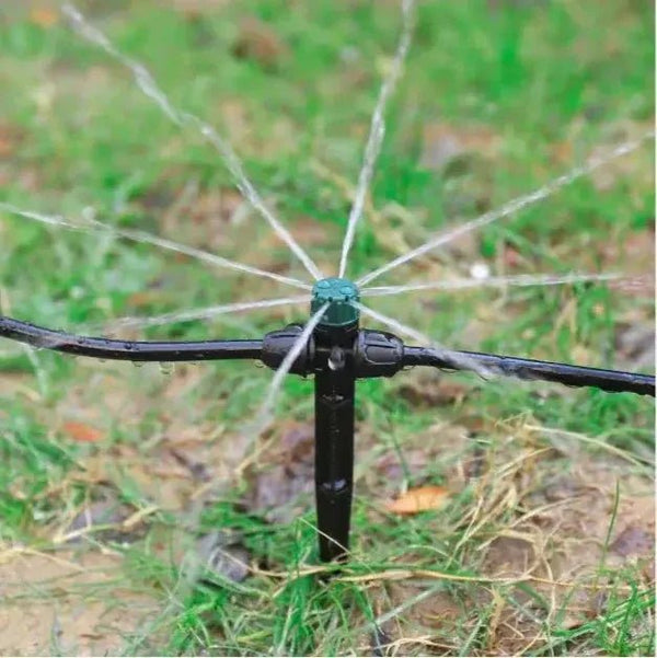 Sprinkler spraying water on grass