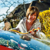 Woman washing a car with a hozelock 2675 spray gun outdoors