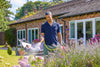 Man standing in a garden with lavender and a house in the background