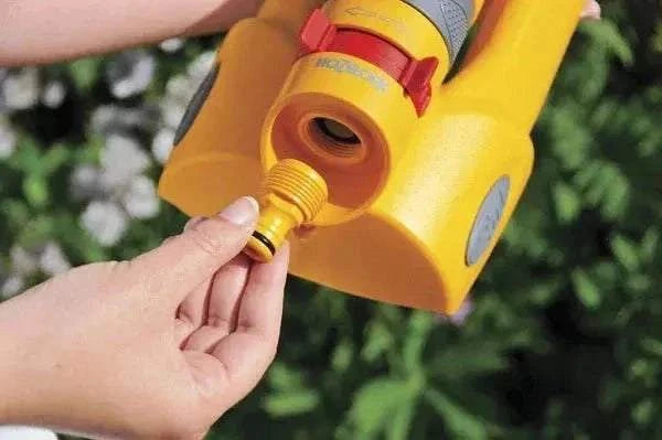 Hozelock Accessory Adapter, yellow plastic garden hose connector with a threaded brass-coloured fitting and red locking clip