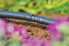 Hozelock 2768 Drip irrigation system in a garden with flowers and soil.