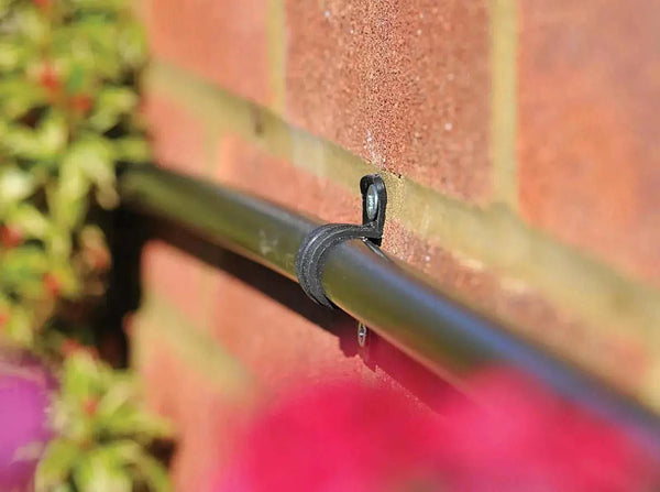 Irrigation Pipe Clip on garden wall