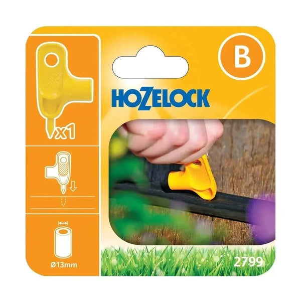 Hozelock Irrigation Hole Punch, yellow plastic handheld tool with a curved grip, shown piercing a pipe on retail packaging.