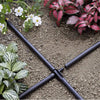 Claber Drip irrigation system on a garden bed with plants and flowers.