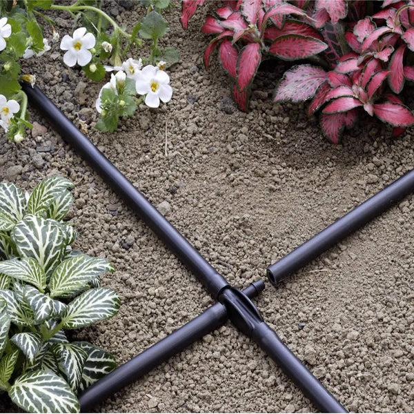 Claber Drip irrigation system on a garden bed with plants and flowers.