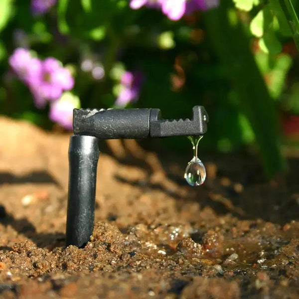 Dripper in action on soil with drip