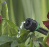 Drip irrigation system watering plants with a green background