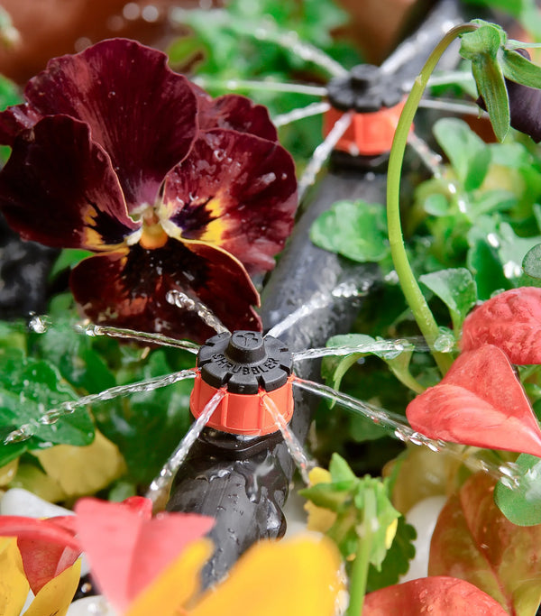 Sprinkler system watering flowers in a garden