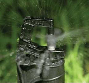 Sprinkler head spraying water on grass