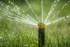 Popup Sprinkler spraying water on grass