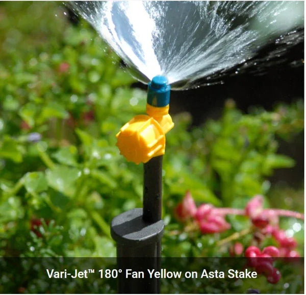 Garden sprinkler with yellow spray head on a green background
