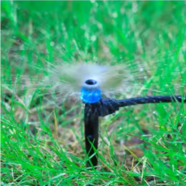 Sprinkler head spraying water on grass