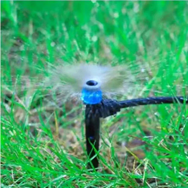Sprinkler head spraying water on grass