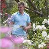 Man watering flowers in a garden