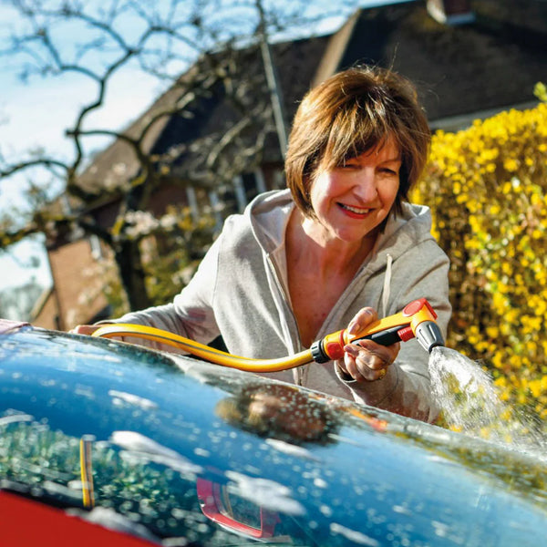 Woman washing a car with a hozelock 2675 spray gun outdoors