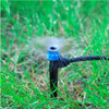 Sprinkler head spraying water on grass